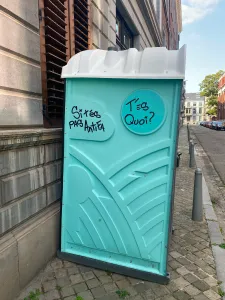 An aqua blue porta potty with 