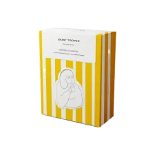 A yellow and white striped cardboard cofee box. On top is a white rectangular sticker that seals the box with Saint-Tropez written on it. On the front of the box is another sticker of a drawing of a person drinking a cup of coffee looking satisfied
