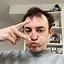 A picture of me with messy hair doing a V sign with my fingers.