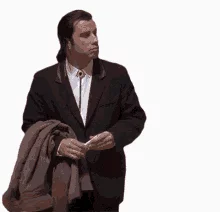 John Travolta looking left and right a bit confused.