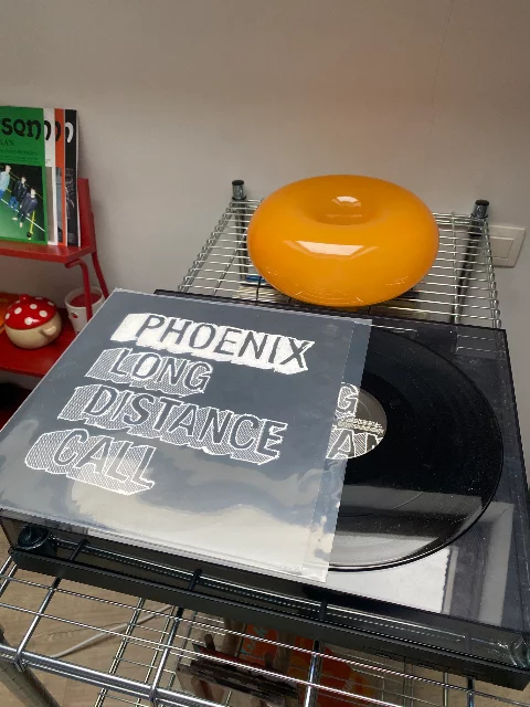Phoenix, Long Distance Call vynil. Sitting on top of my turntable with a orange donut lamp in the background.